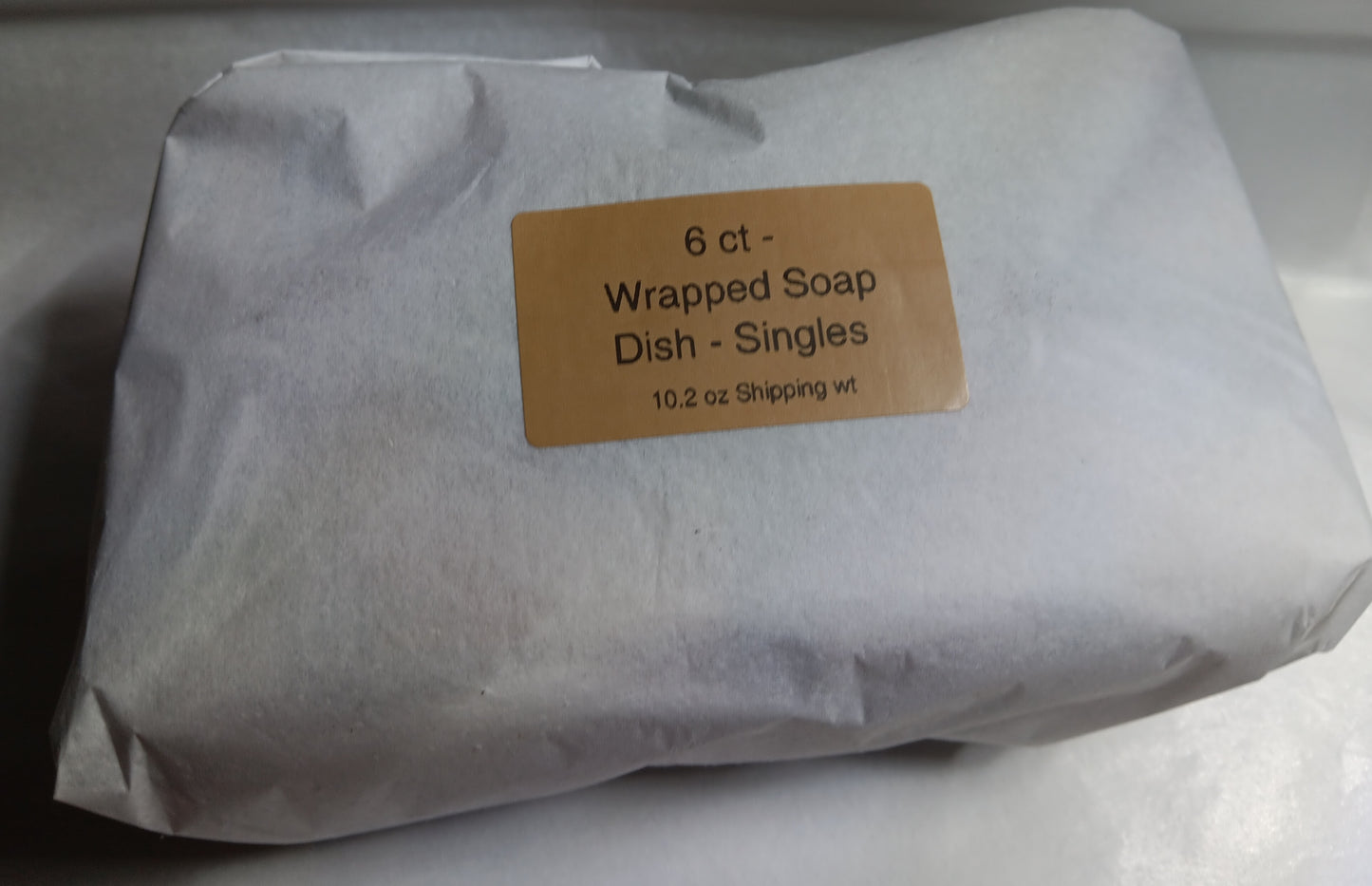 Package of 6 count wrapped soap dishes with a label on a white background