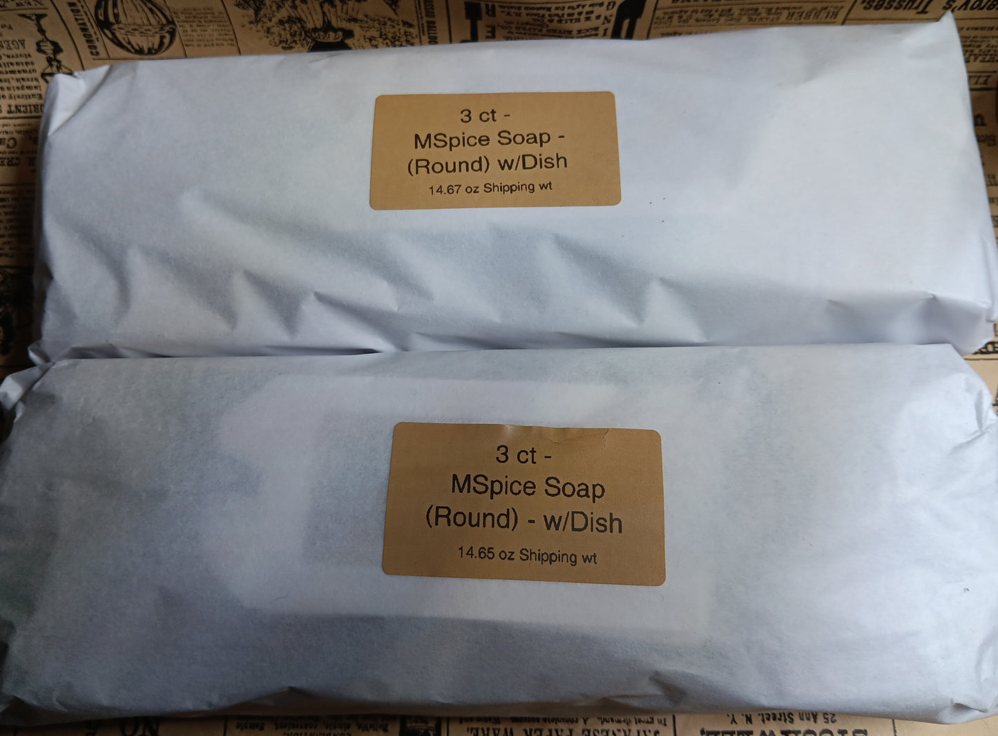 Two 3 count packages of Morroccan Spice Soap with labels on a vintage newsprint background